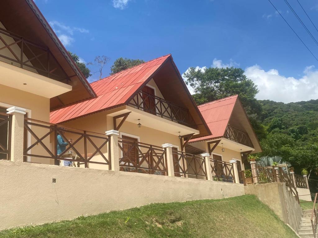 ein Haus mit rotem Dach in der Unterkunft Chalé Kalmaria in Guaramiranga