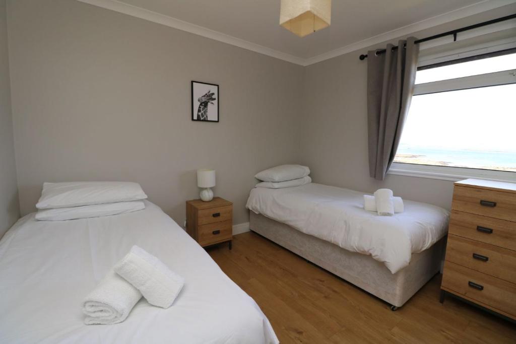a bedroom with two beds and a window at Borve House, Kilchoan in Kilchoan