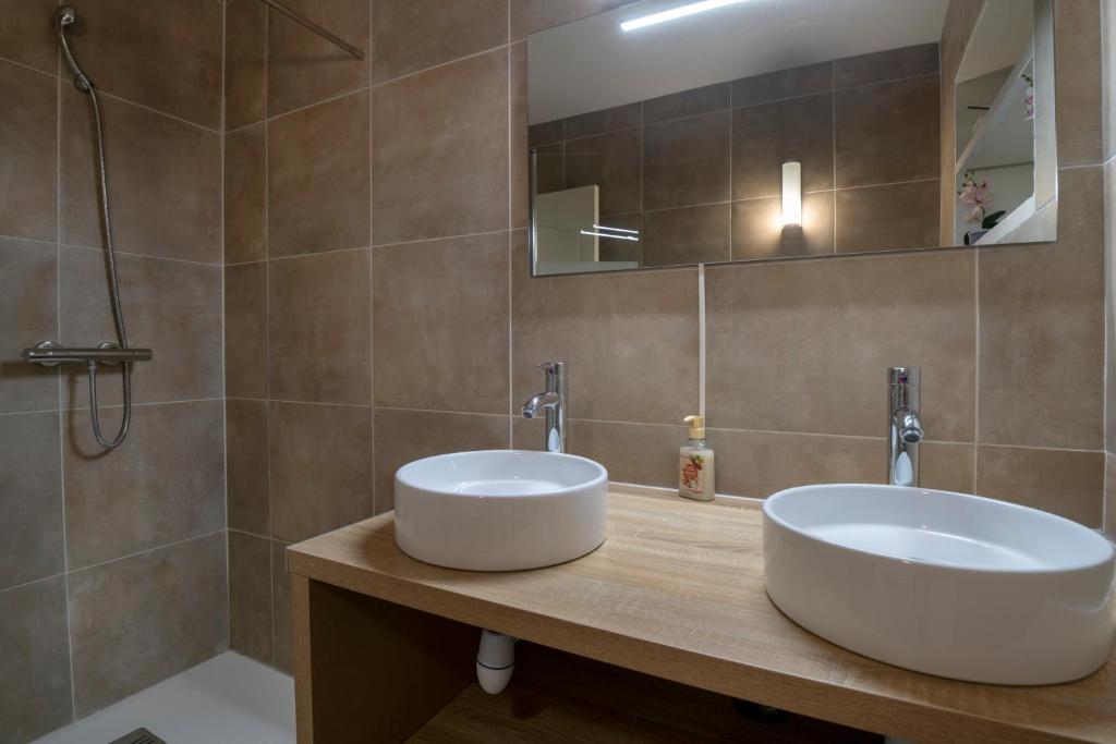 a bathroom with a white sink and a mirror at Charmant pavillon bordelais (logement entier) in Saint-Médard-en-Jalles