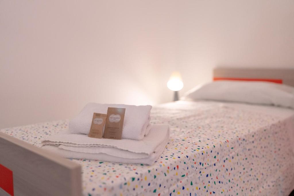 Letto o letti in una camera di Cortile dei Giusti - Combo Guesthouse