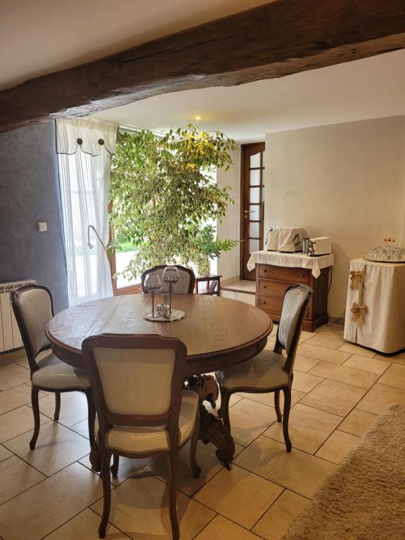 a dining room with a table and chairs at La Merlette89 in Lailly