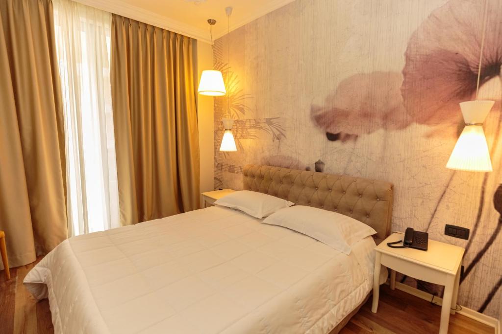 Postel nebo postele na pokoji v ubytování Regina City Hotel & SPA
