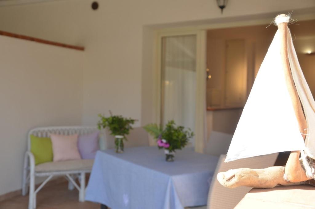 a living room with a table and a teddy bear at Appartamento Genziana in Santa Maria Navarrese