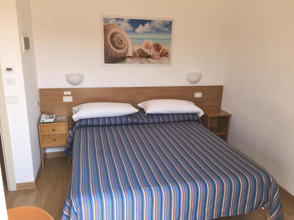 Postel nebo postele na pokoji v ubytování Hotel Mayor