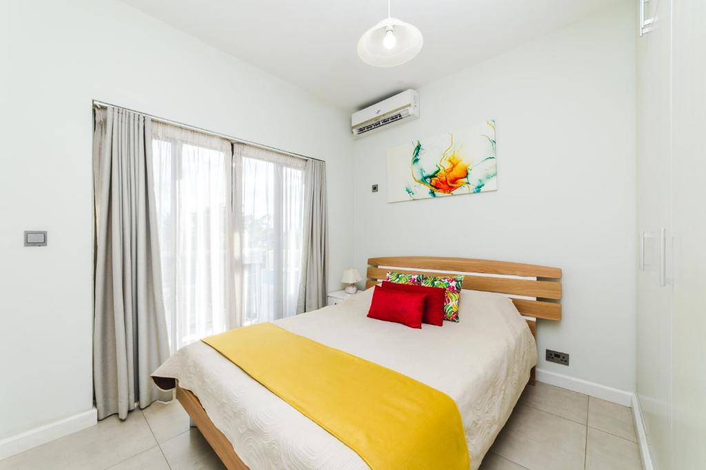 Postel nebo postele na pokoji v ubytování Beachcove Apartment 9 in Pereybere