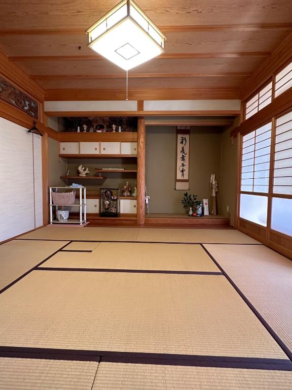 a large room with a wooden ceiling and a chinese room at Curfew by midnight Guesthouse Tosa Hanare - Vacation STAY 14262 in Kochi