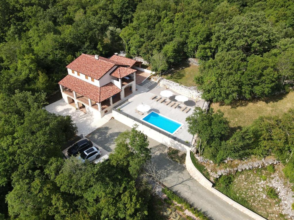 an aerial view of a house with a swimming pool at Amazing 4 bedroom villa with Swimming pool and WIFI, family frendly in Tribalj