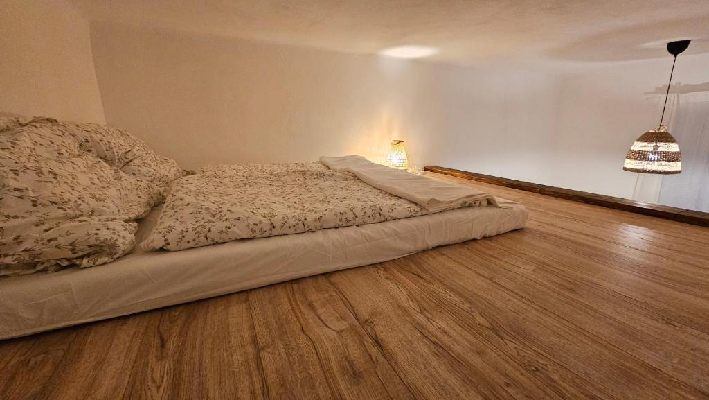 a bed in a room with a wooden floor at surf.Lend in Graz