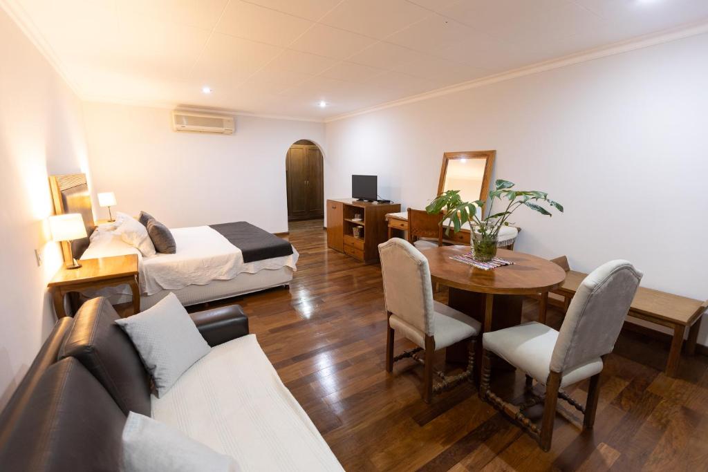 a hotel room with a bed and a table and chairs at Terrazas Vista Verde in Asunción