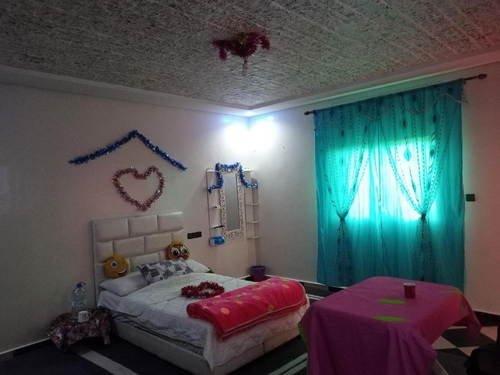 een slaapkamer met een bed en een tafel. bij 卡萨布兰卡豪华别墅，距离穆罕默德5机场10分钟 in Casablanca