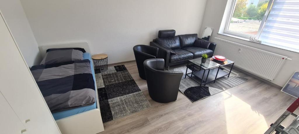 a living room with a couch and a chair at 2 ZKB Apartment City/Krefeld, Monteure,Netflix,Prime in Krefeld