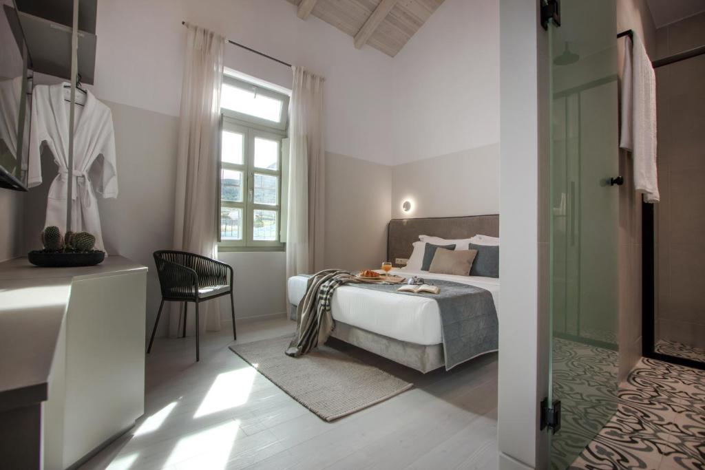 Postel nebo postele na pokoji v ubytování Octavia Rooms