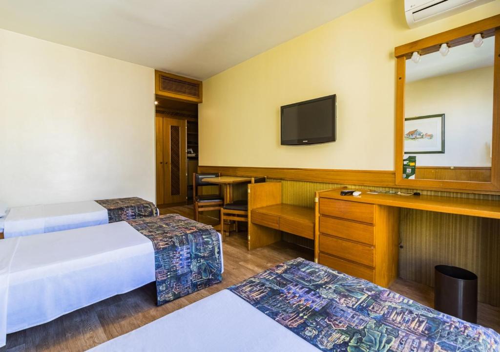Postel nebo postele na pokoji v ubytování Ritter Hotéis