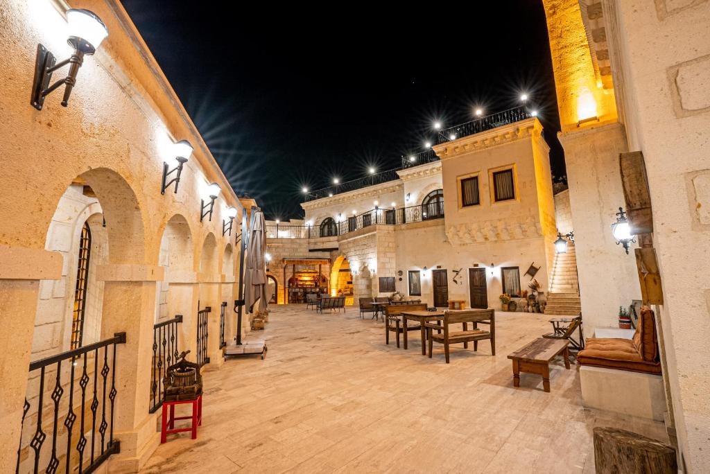 a large courtyard with tables and chairs in a building at Nujel'm Cappadocia in Ürgüp