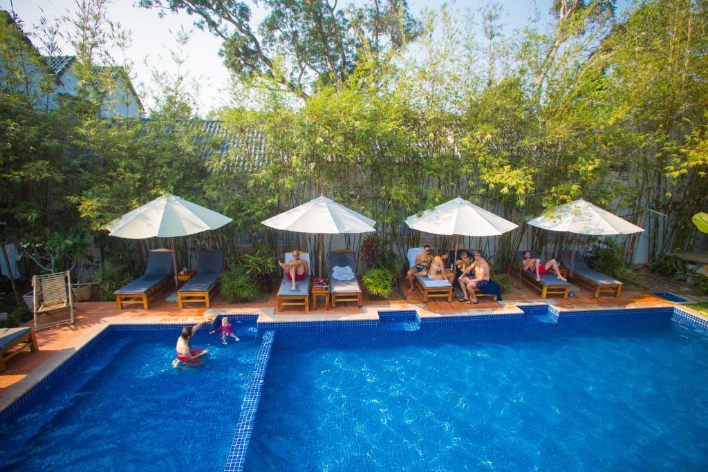 a group of people sitting in a swimming pool at La Mer Resort, Phú Quốc in Phú Quốc