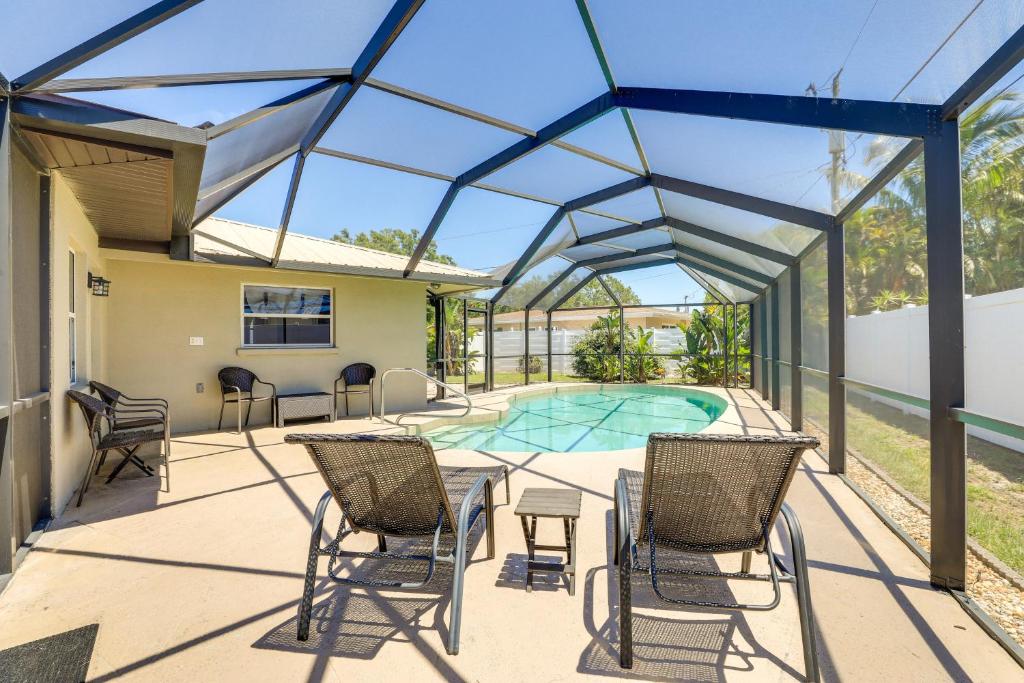 a patio with chairs and a swimming pool at Sarasota House with Private Pool - 4 Mi to Beach! in Sarasota