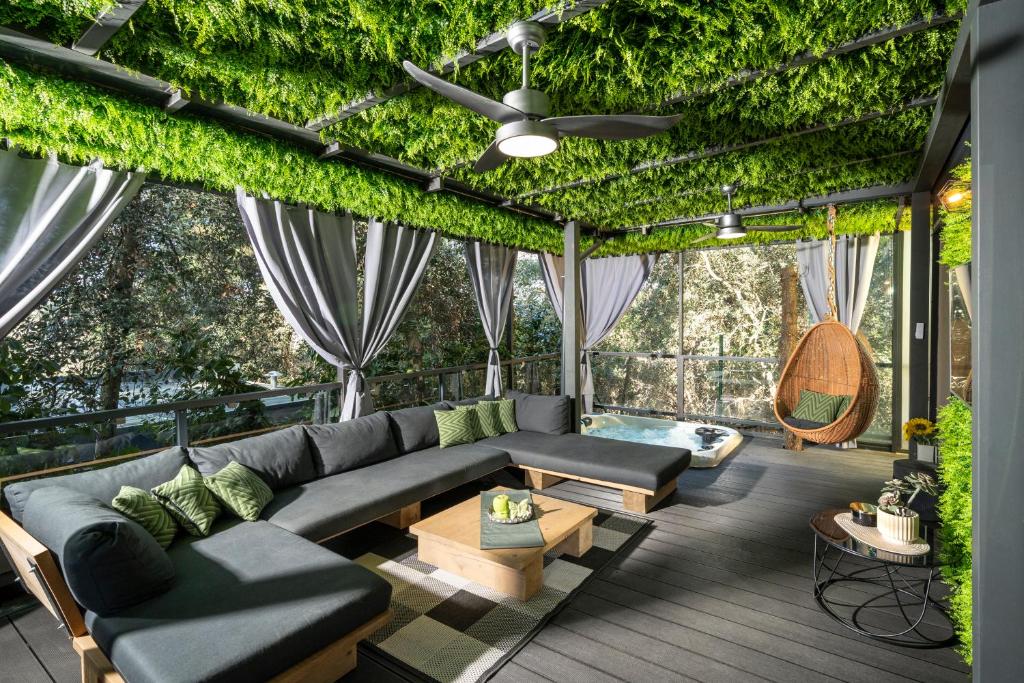 a living room with a couch and a ceiling covered in ivy at Mobile Home JOY Porton Biondi in Rovinj