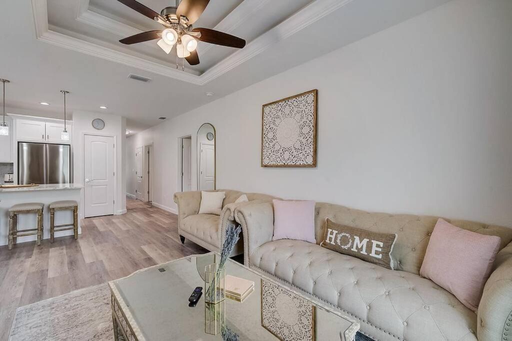 a living room with a couch and a ceiling fan at South West Florida Family Home, 3 Bedroom,2 Bathroom, King bed suite, Close to Beaches, Parks, Fishing, Golfing, Kayaking in Rotonda West