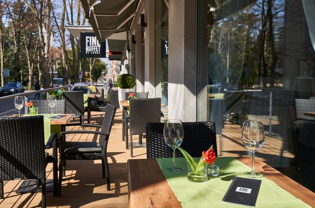 a table with wine glasses on top of it on a patio at Spa Hotel Felicitas in Poděbrady