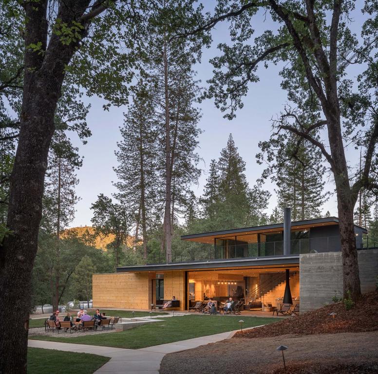 a house in the middle of a park with trees at AutoCamp Yosemite in Midpines