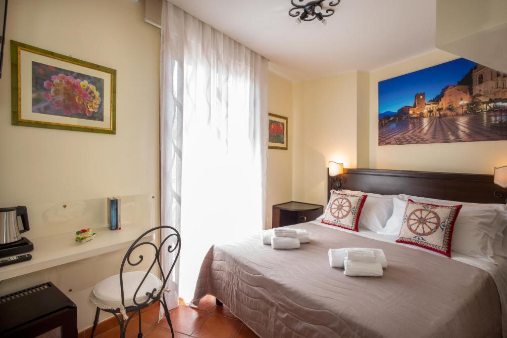 a bedroom with a bed with towels on it at B&B RE TANCREDI in Taormina