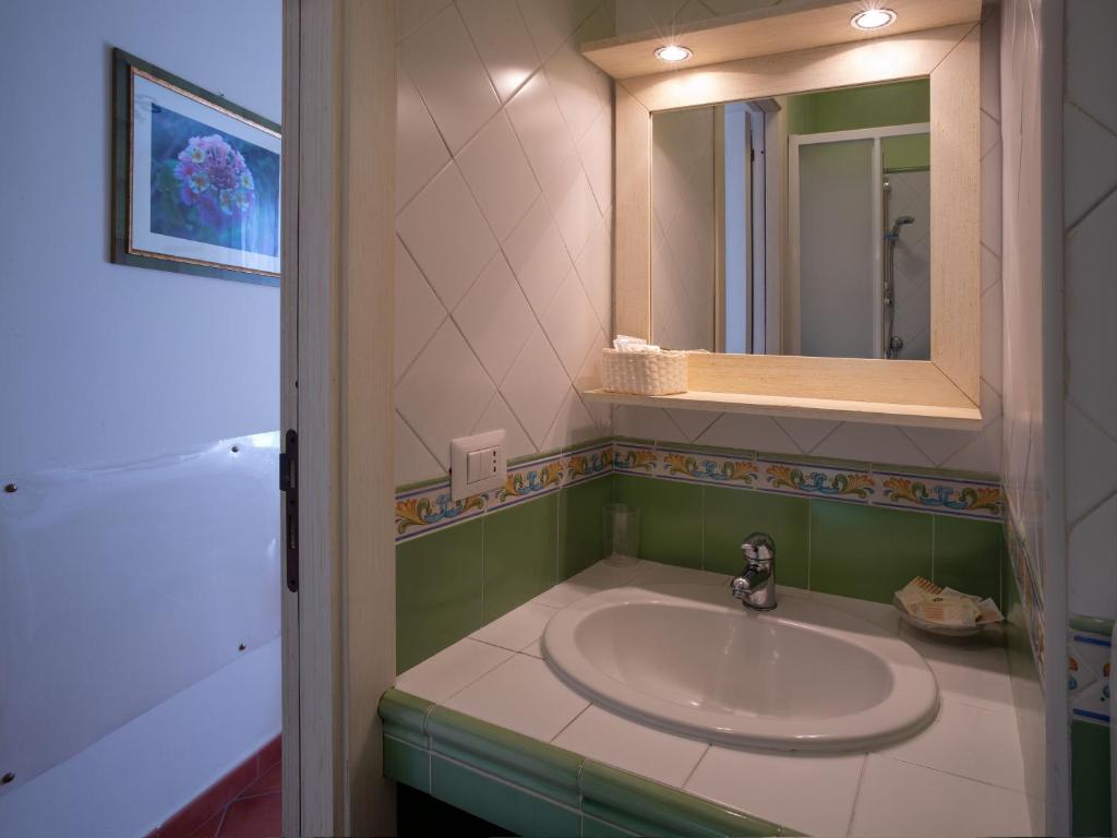 a bathroom with a sink and a mirror at B&B RE TANCREDI in Taormina