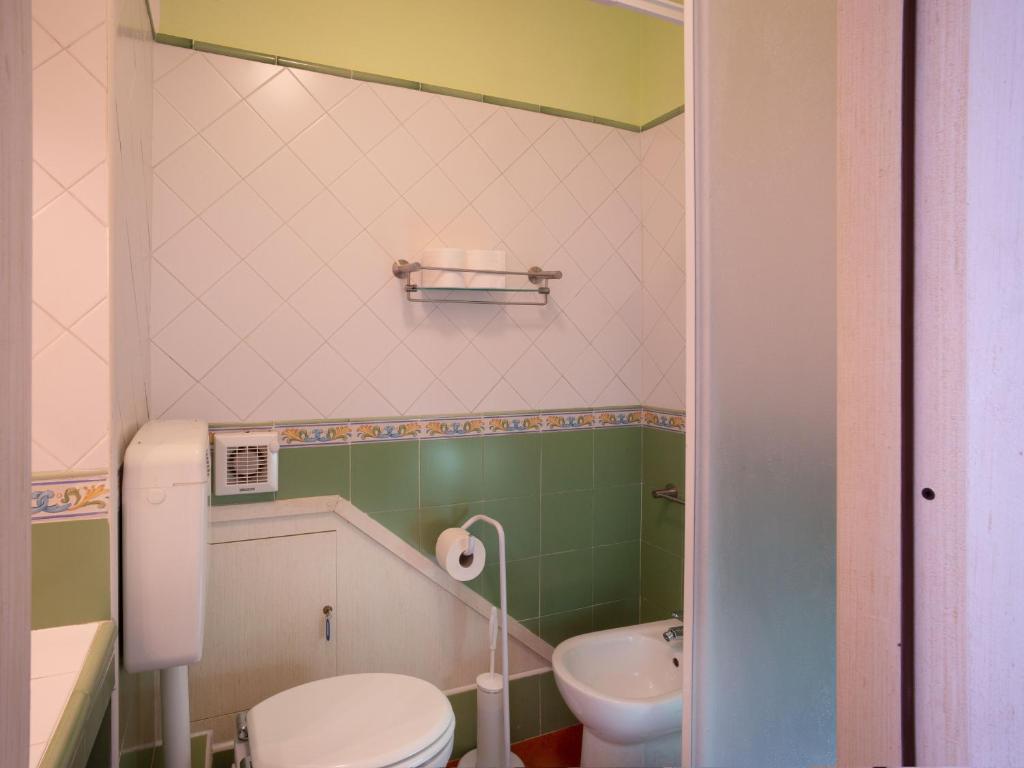 a small bathroom with a toilet and a sink at B&B RE TANCREDI in Taormina