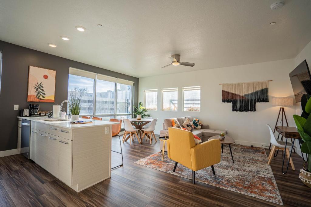 a kitchen and living room with a couch and a table at Charming Retreat in Heart of SLC in Salt Lake City