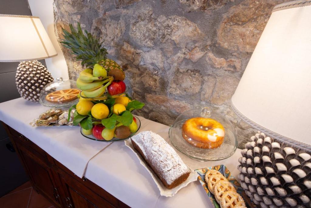 a table with a bunch of fruit and bread on it at B&B RE TANCREDI in Taormina