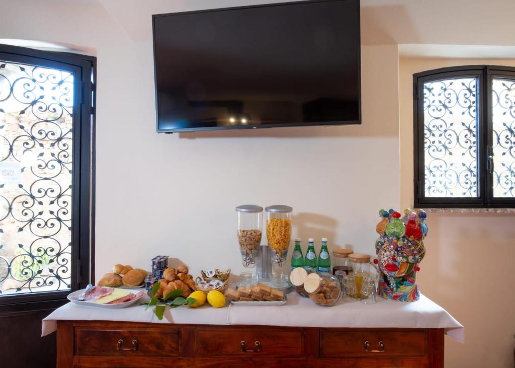 a table with food on top of it with windows at B&B RE TANCREDI in Taormina