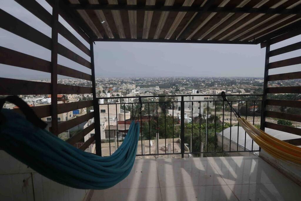 a balcony with hammocks and a view of a city at Jericho Palestine, Panorama Villa- View, Full Privacy & Pool in Jericho