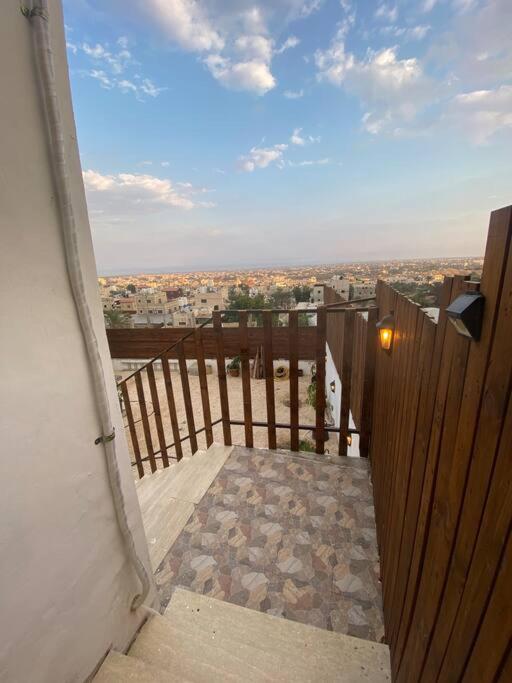 an open door to a balcony with a view of a city at Jericho Palestine, Panorama Villa- View, Full Privacy & Pool in Jericho