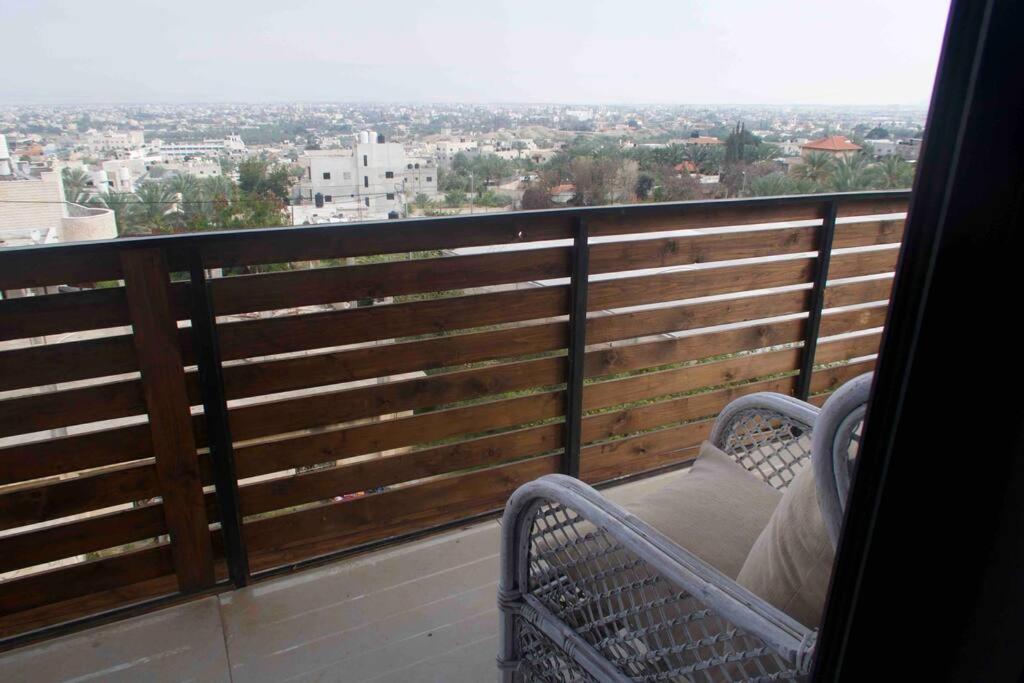 a balcony with a chair and a view of a city at Jericho Palestine, Panorama Villa- View, Full Privacy & Pool in Jericho