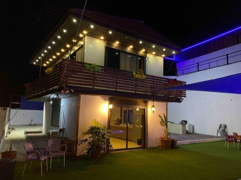 a house with a balcony with lights on it at Jericho Palestine, Panorama Villa- View, Full Privacy & Pool in Jericho