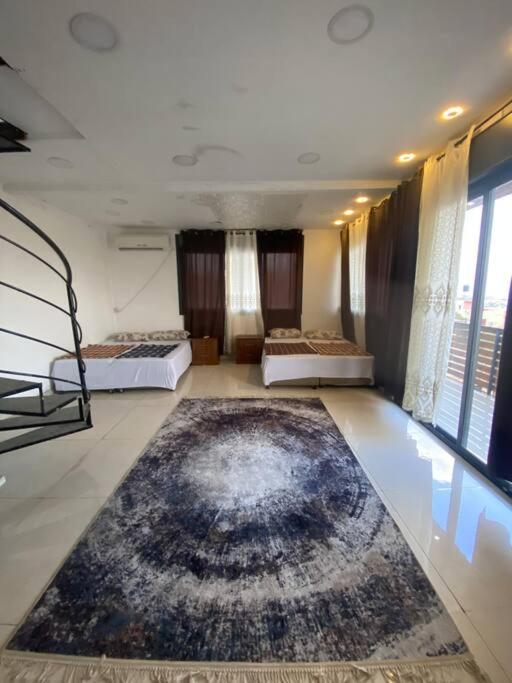 a room with two beds and a rug on the floor at Jericho Palestine, Panorama Villa- View, Full Privacy & Pool in Jericho