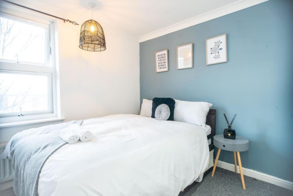 a bedroom with a white bed and a window at Spacious 1 Bed- Nunhead/Peckham-sleeps 4 in London