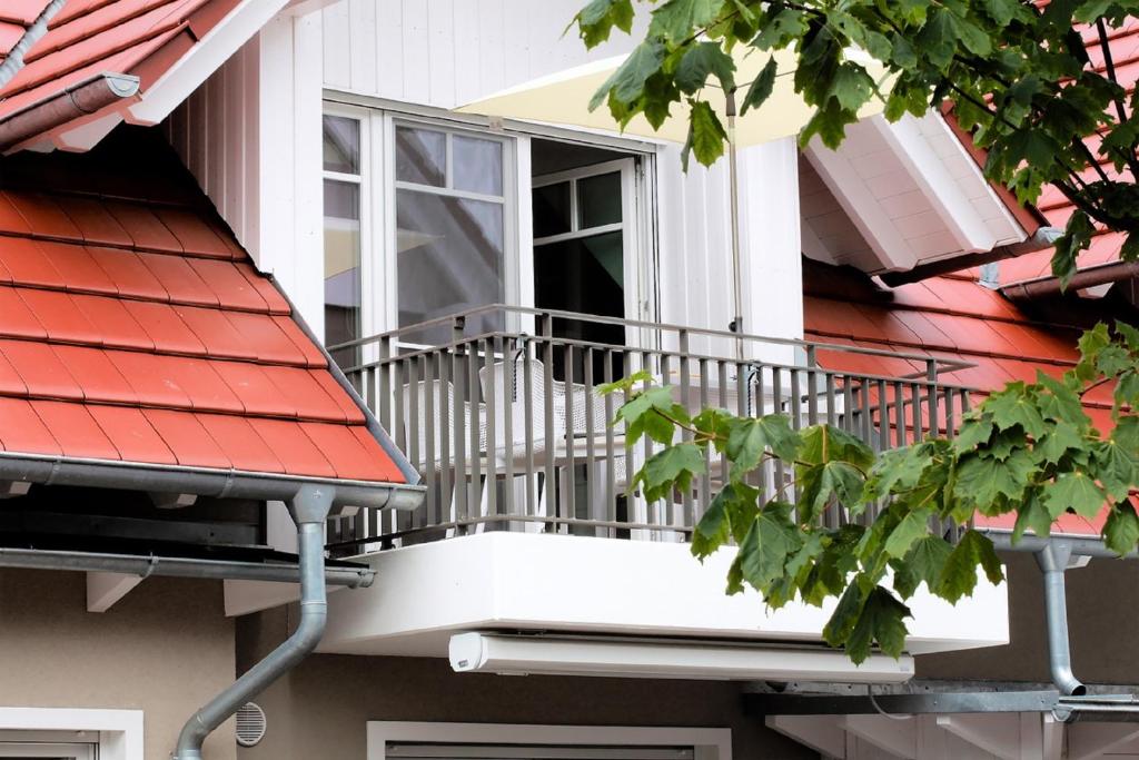 a balcony on a house with a window at FeWo Bark Middenmang in Wustrow