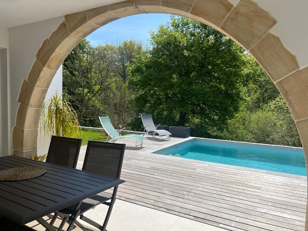 a patio with a table and a swimming pool at Appartement Ciboure, 3 pièces, 4 personnes - FR-1-239-927 in Ciboure