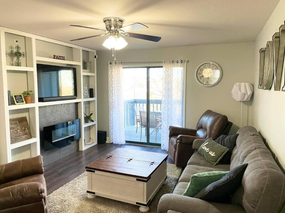 a living room with a couch and a table at Luxury Family Condo w/ Great Views & Entertainment in Branson