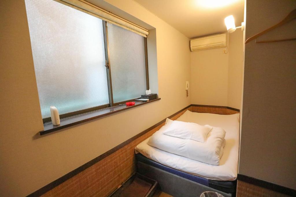 Postel nebo postele na pokoji v ubytování プチホテル　コスモス