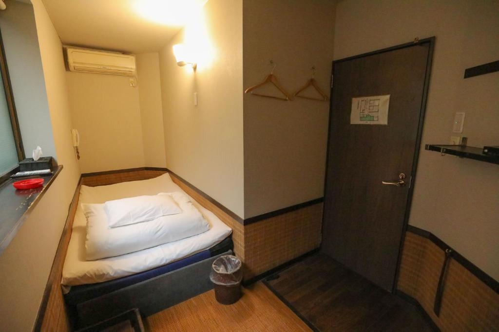 Postel nebo postele na pokoji v ubytování プチホテル　コスモス