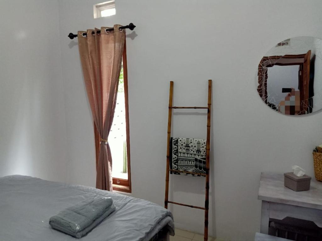 Postel nebo postele na pokoji v ubytování rindoe jogja holiday home