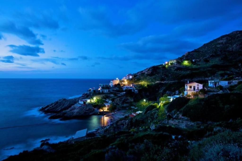 a small town on a hill at night at Icarus home in Kouniádhoi