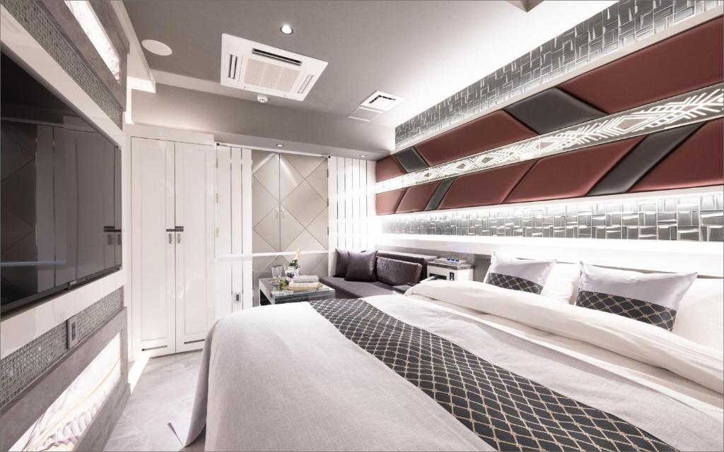 Postel nebo postele na pokoji v ubytování HOTEL KABUKI