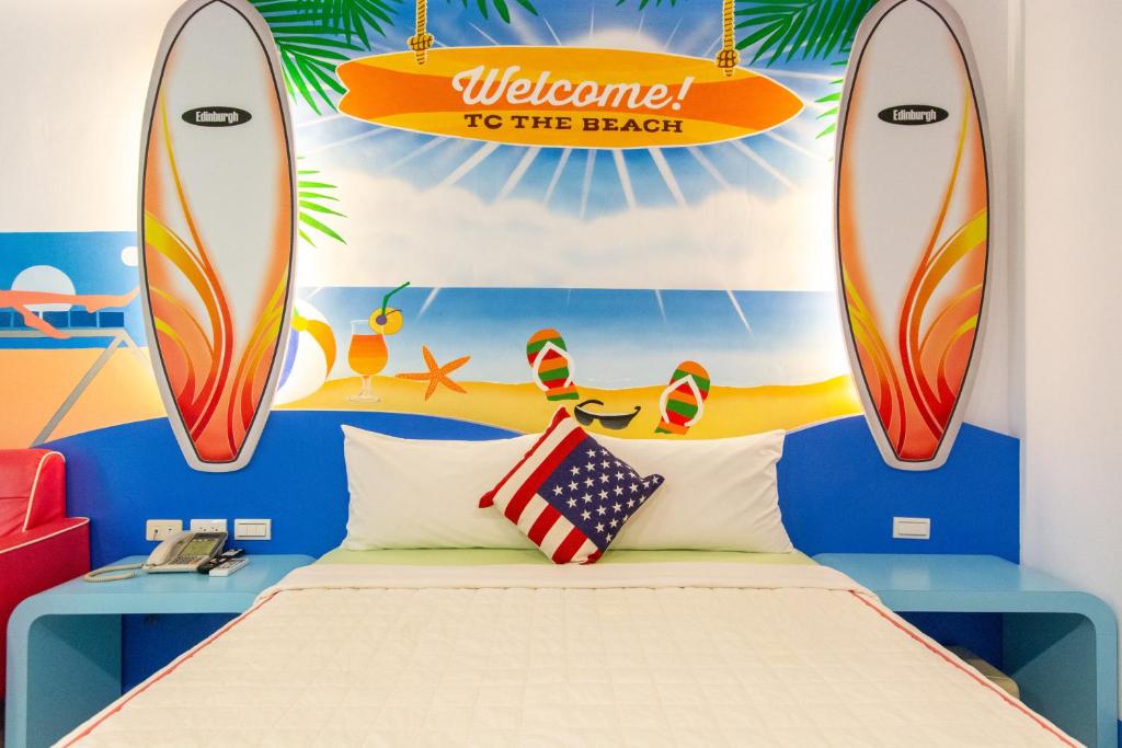 a bedroom with a bed and surfboards on the wall at Ocean Star B&amp;B in Kenting
