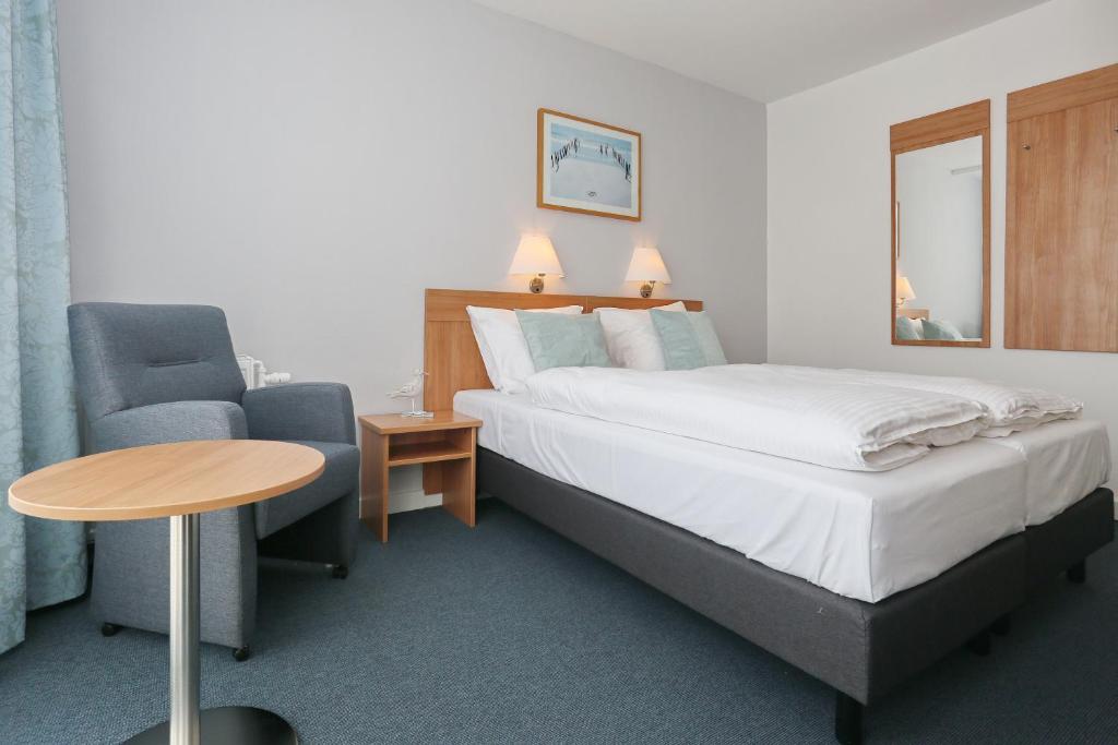 Een bed of bedden in een kamer bij Hotel Golfzicht