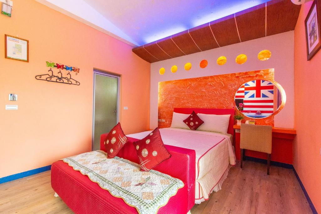 a bedroom with a bed and a table and a chair at Ocean Star B&amp;B in Kenting