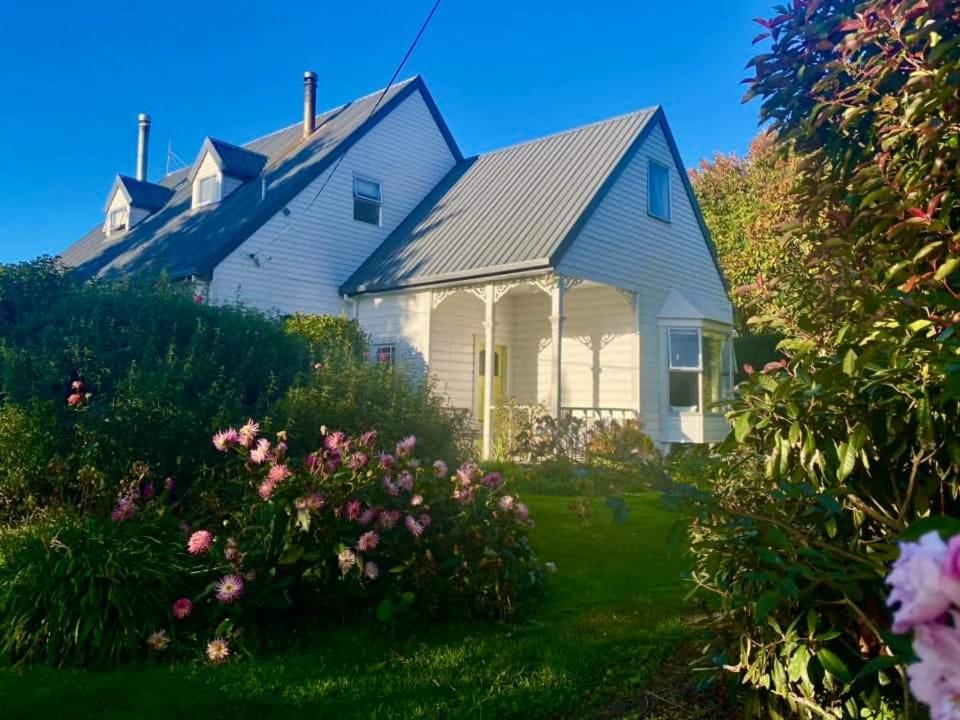 a white house with a gray roof at Windhaven Bed & Breakfast in Duntroon