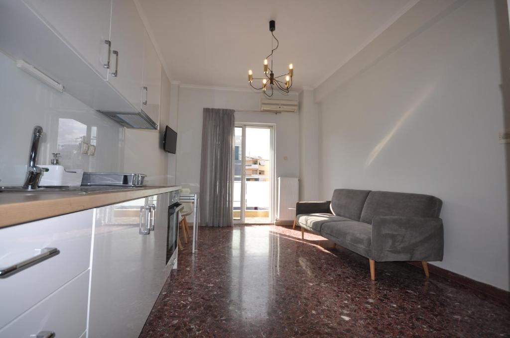 a living room with a couch and a kitchen at Apartments Chania in Chania Town