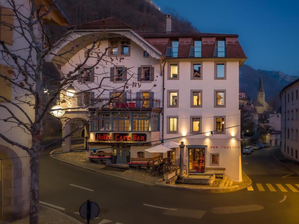 a large white building on the side of a street at Tralala Hotel Montreux in Montreux